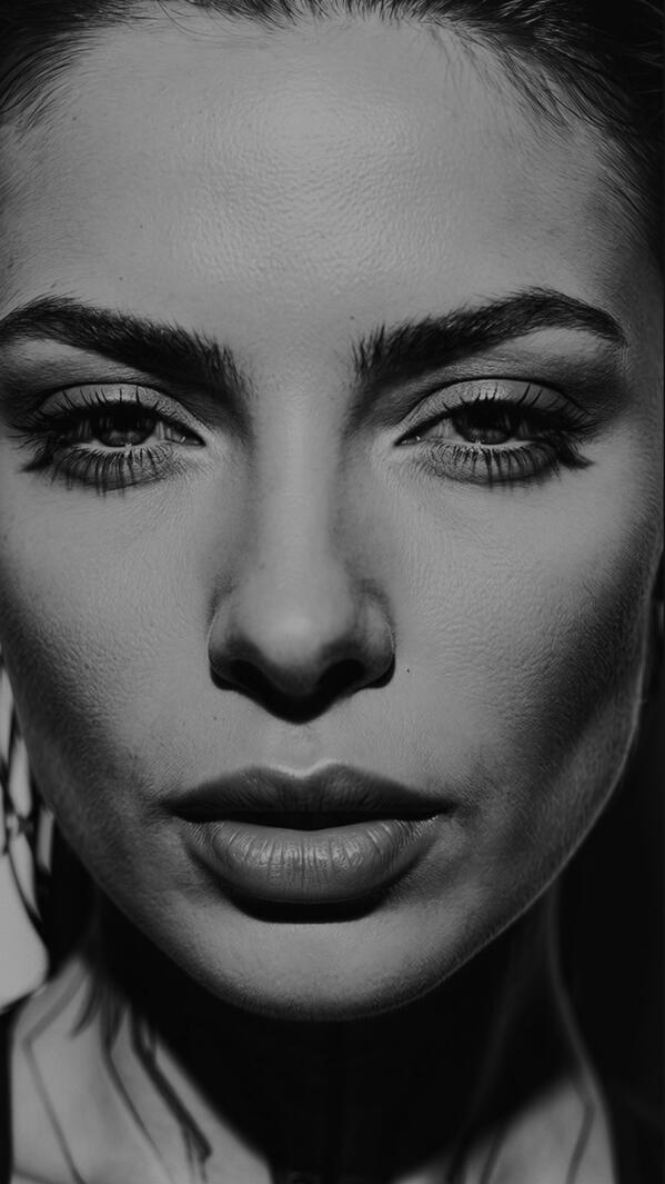 Studio portrait of Mia Liorvian in champagne satin dress and lace sleeves, hard light.